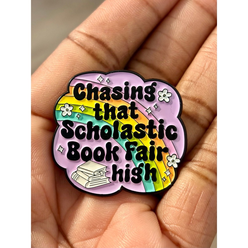 Chasing that Scholastic Book Fair High Enamel Pin